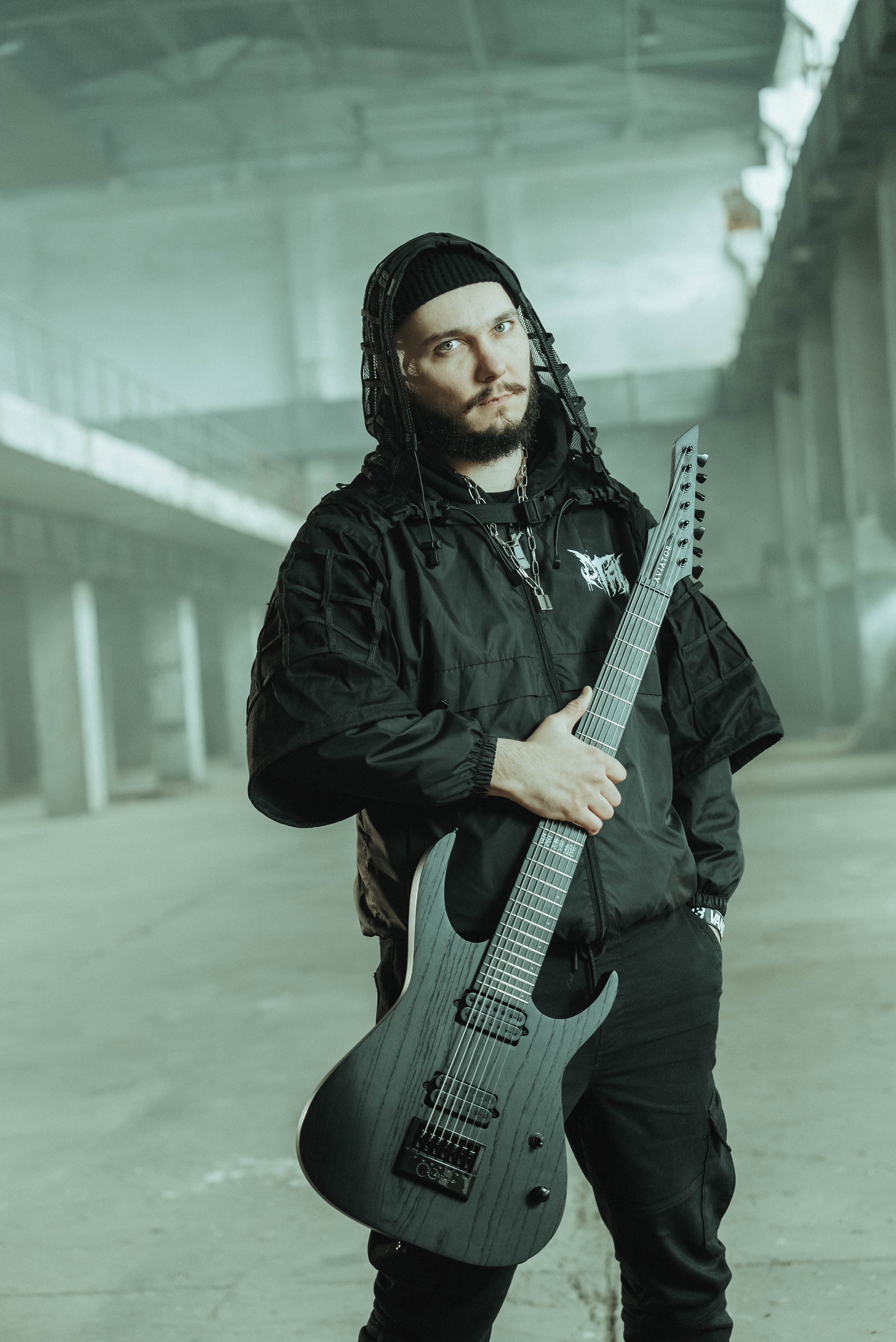 Portrait with guitar in an industrial warehouse